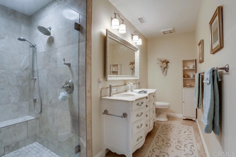 653 Marsolan Avenue Solana Beach, CA 92075 - Photo 24 of 29 a bathroom with a double vanity sink toilet mirror and shower