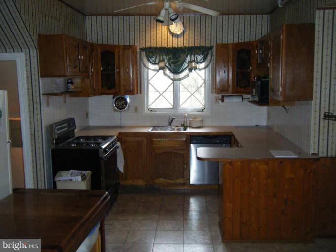 208 West Maple Road Linthicum Heights, MD 21090 - Photo 2 of 19 a kitchen with a sink stove and cabinets