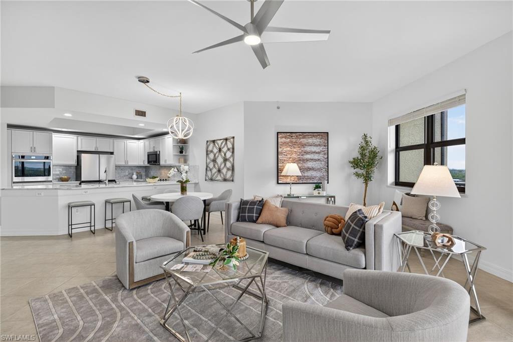 Living area with light tile patterned floors and a ceiling fan