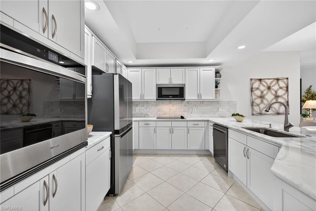 14380 Riva Del Lago Drive, Unit 802 Fort Myers, FL 33907 - Photo 11 of 49 a kitchen with a sink cabinets and stainless steel appliances