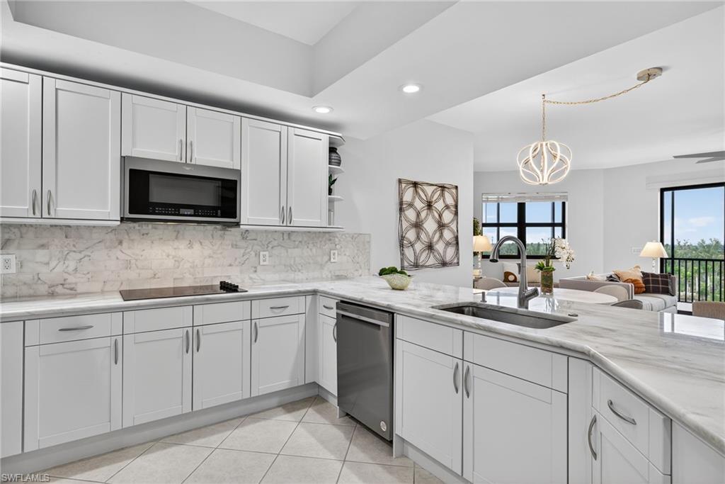 14380 Riva Del Lago Drive, Unit 802 Fort Myers, FL 33907 - Photo 12 of 49 a kitchen with cabinets stainless steel appliances a sink and a window