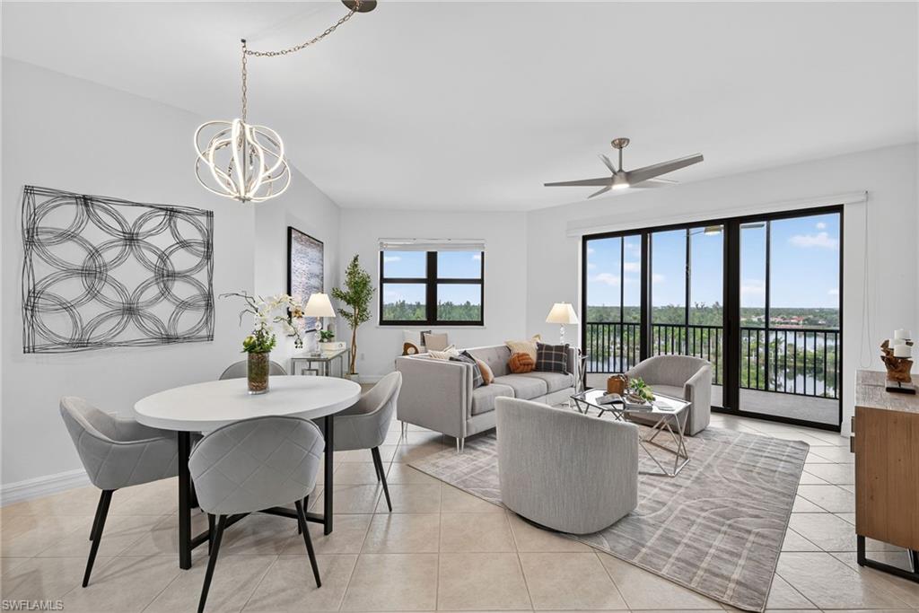 14380 Riva Del Lago Drive, Unit 802 Fort Myers, FL 33907 - Photo 15 of 49 a dining room with furniture a chandelier and wooden floor