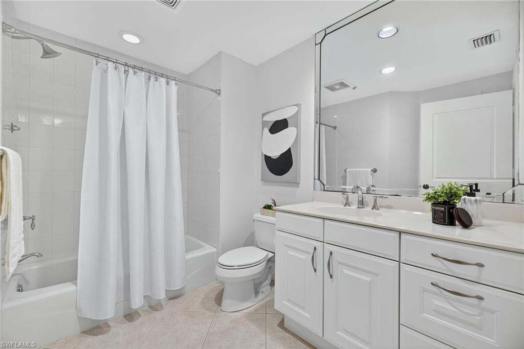 14380 Riva Del Lago Drive, Unit 802 Fort Myers, FL 33907 - Photo 23 of 49 a bathroom with a toilet a sink a tub and mirror