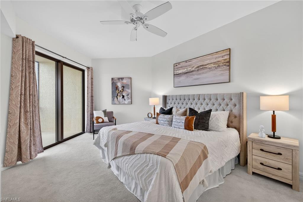 14380 Riva Del Lago Drive, Unit 802 Fort Myers, FL 33907 - Photo 6 of 49 a bedroom with a large bed and a chandelier