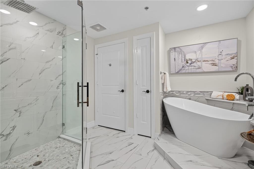 14380 Riva Del Lago Drive, Unit 802 Fort Myers, FL 33907 - Photo 7 of 49 a bathroom with a bathtub and a shower