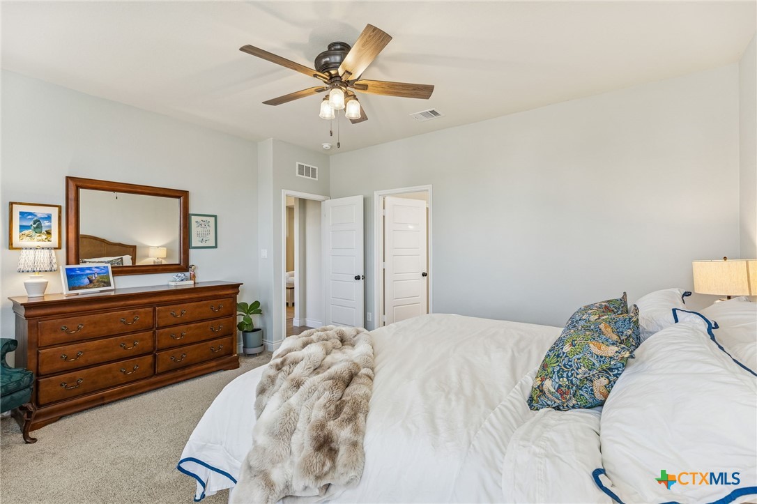 4008 Wild Bloom Road Seguin, TX 78155 - Photo 17 of 40 a bedroom with a bed and a dresser