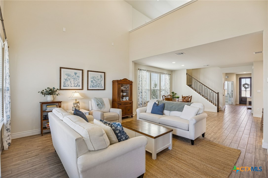 4008 Wild Bloom Road Seguin, TX 78155 - Photo 5 of 40 a living room with furniture and a wooden floor