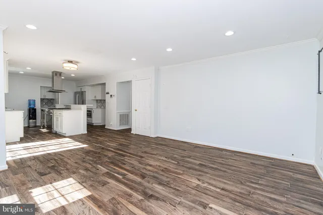 a view of kitchen view wooden floor and kitchen view