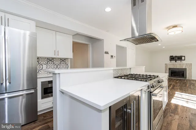 a kitchen with a stove a refrigerator and a sink