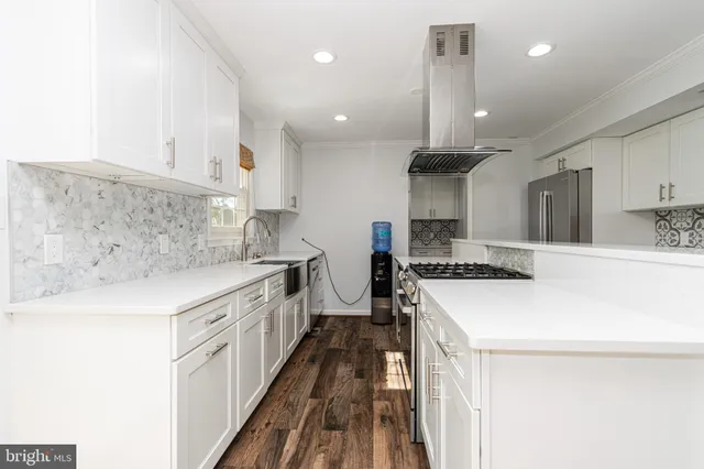 a kitchen with stainless steel appliances sink stove and cabinets