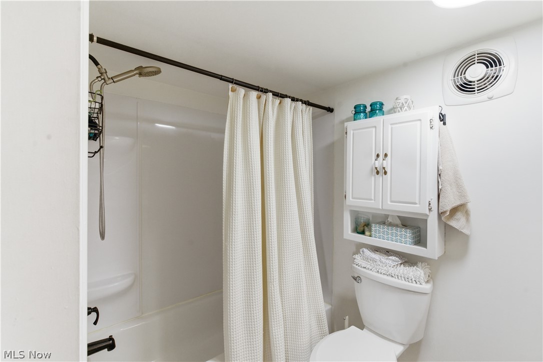 52450 Tower Road Cumberland, OH 43732 - Photo 9 of 41 Bathroom featuring shower / bath combo and toilet