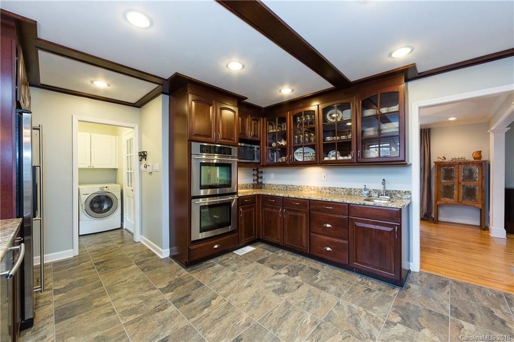 4615 Walker Road Charlotte, NC 28211 - Photo 12 of 28 a kitchen with stainless steel appliances granite countertop a refrigerator and a sink