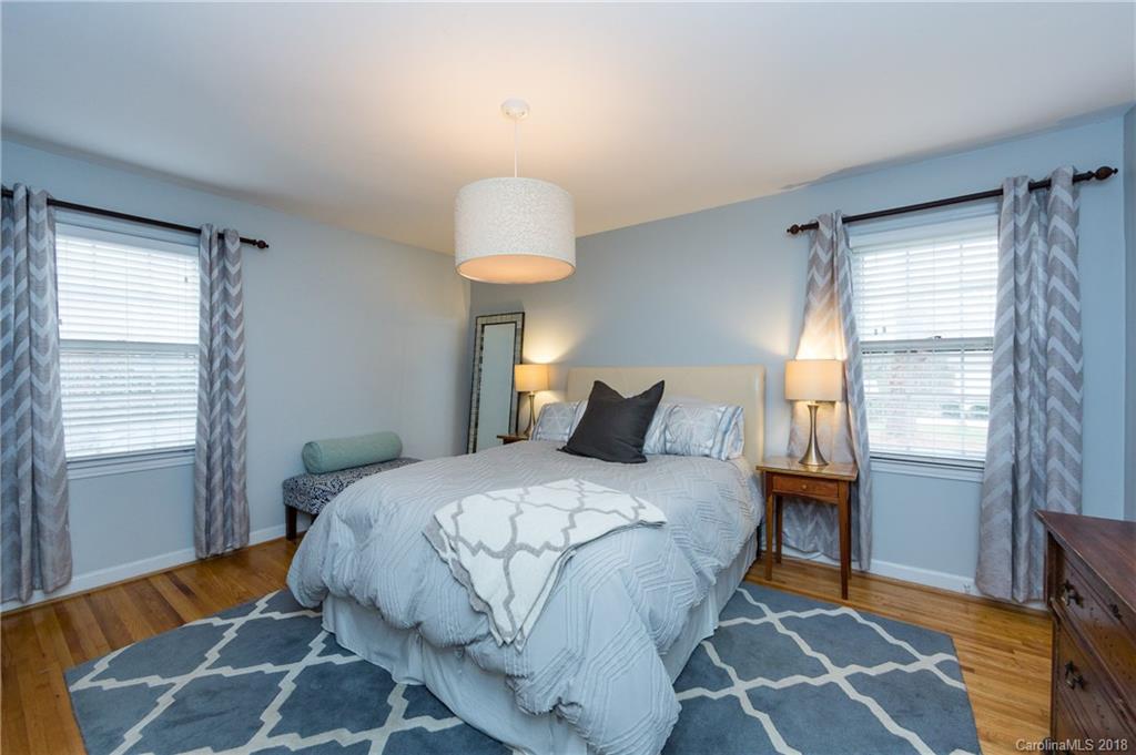 4615 Walker Road Charlotte, NC 28211 - Photo 15 of 28 a bedroom with a bed and a table lamp
