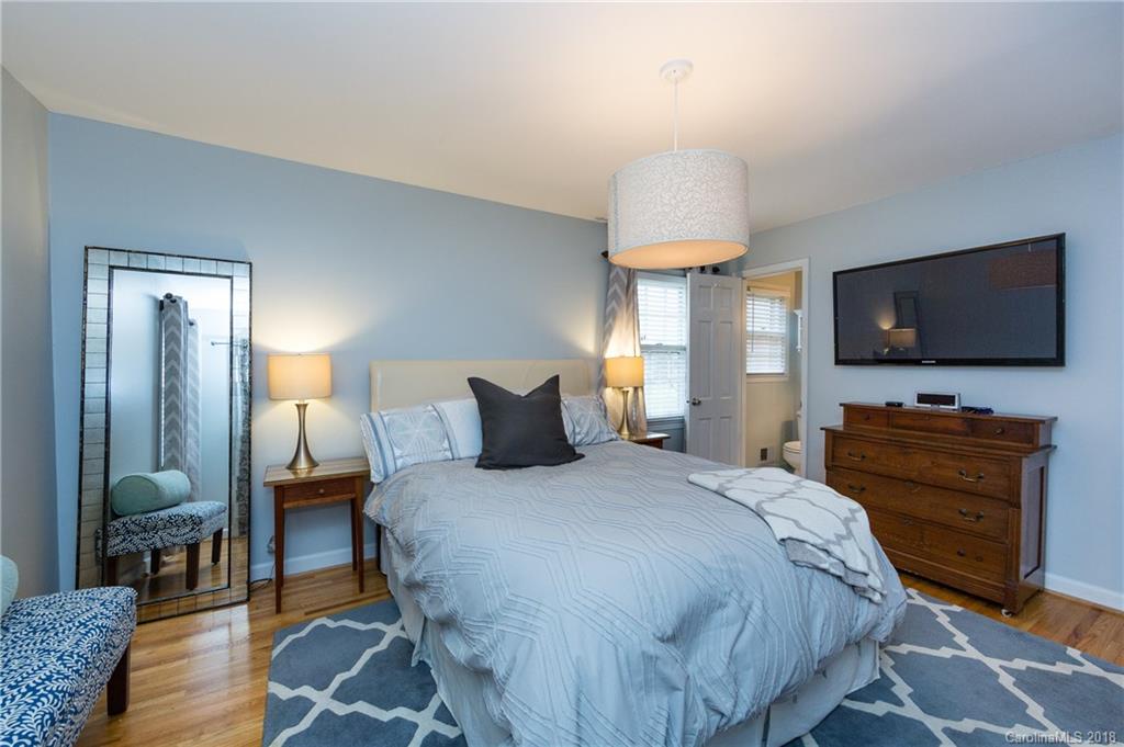 4615 Walker Road Charlotte, NC 28211 - Photo 16 of 28 a bedroom with a bed and a flat screen tv