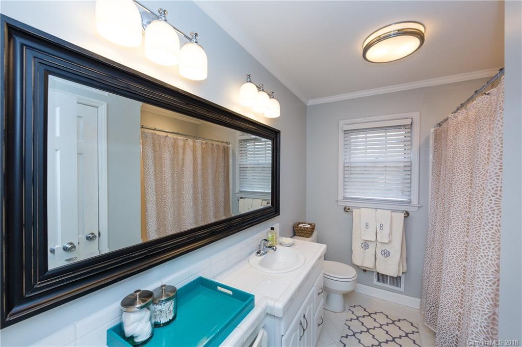 4615 Walker Road Charlotte, NC 28211 - Photo 18 of 28 a bathroom with a sink vanity granite and a mirror