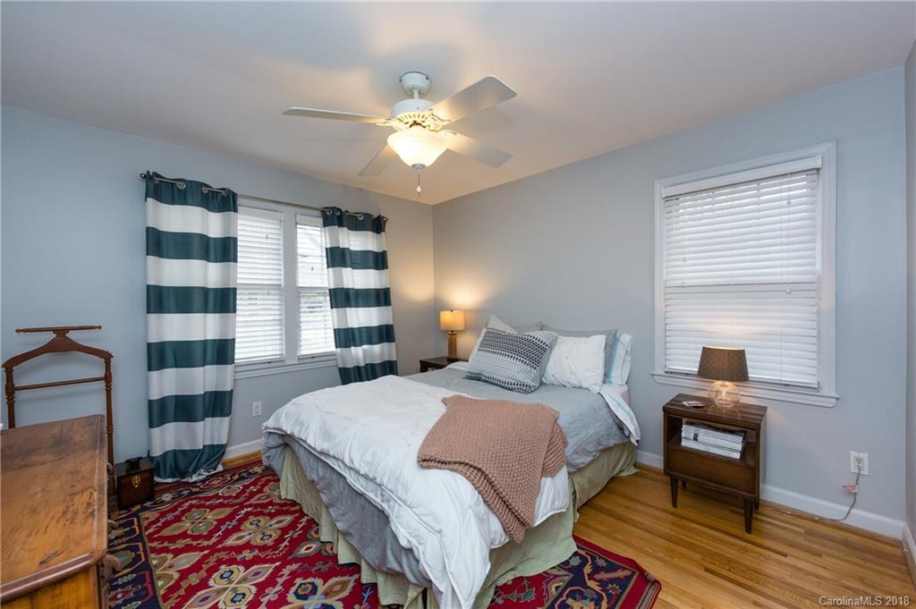 4615 Walker Road Charlotte, NC 28211 - Photo 19 of 28 a bedroom with a bed and a bookshelf with wooden floor