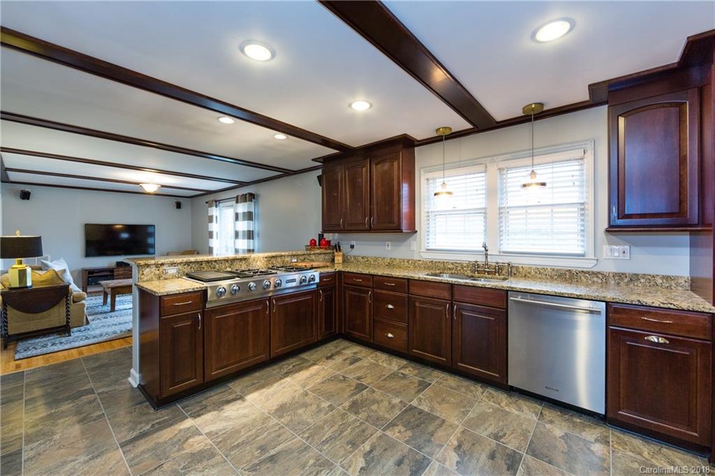 4615 Walker Road Charlotte, NC 28211 - Photo 9 of 28 a large kitchen with stainless steel appliances granite countertop a sink and cabinets