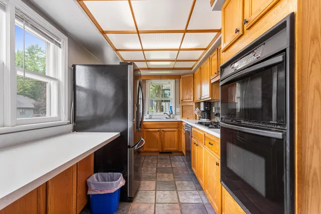 a kitchen with stainless steel appliances a refrigerator a sink a stove and cabinets