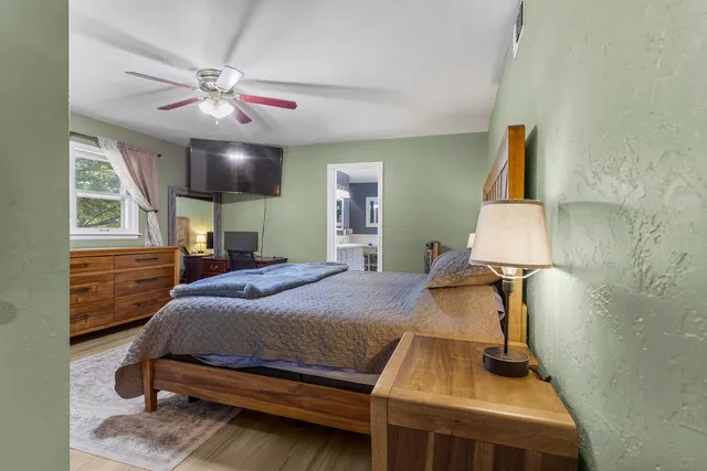 a bedroom with a bed and a chandelier