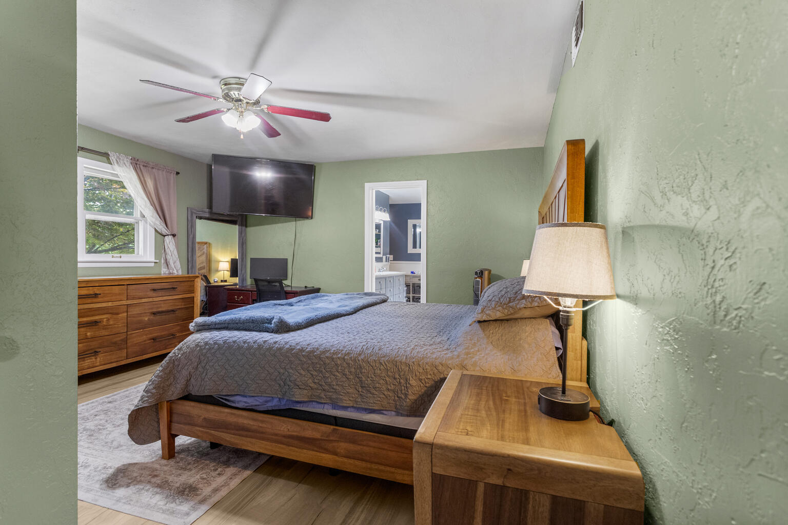 504 South West Union Street Monticello, IL 61856 - Photo 17 of 35 a bedroom with a bed and a chandelier