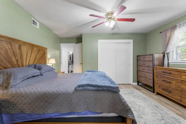 a living room with furniture and a dresser