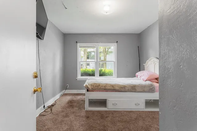 a bedroom with a bed and window