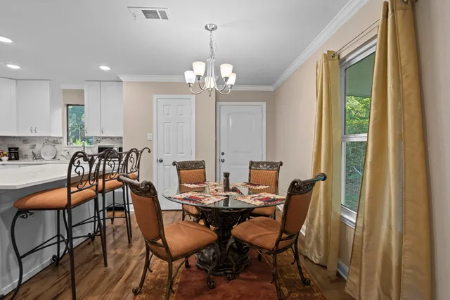 a kitchen with white cabinets and appliances
