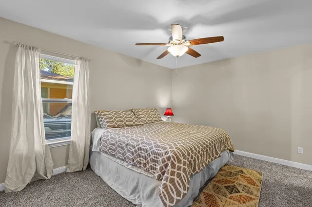 a bedroom with a large bed and a chandelier