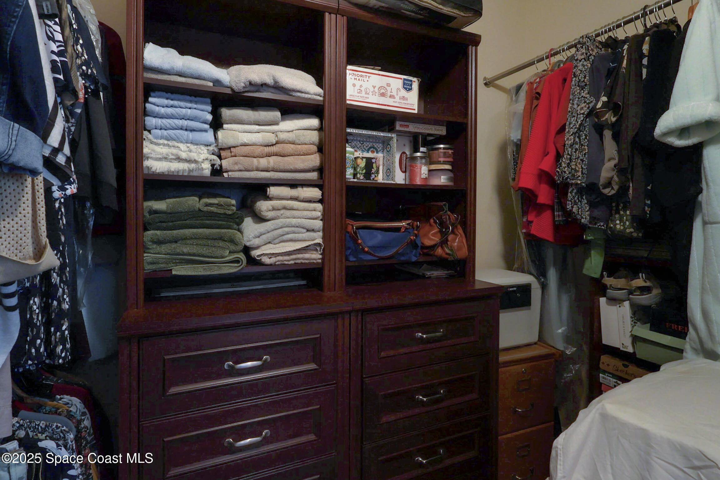 249 Franzing Street Palm Bay, FL 32908 - Photo 14 of 38 a view of walk in closet with clothes and shoes