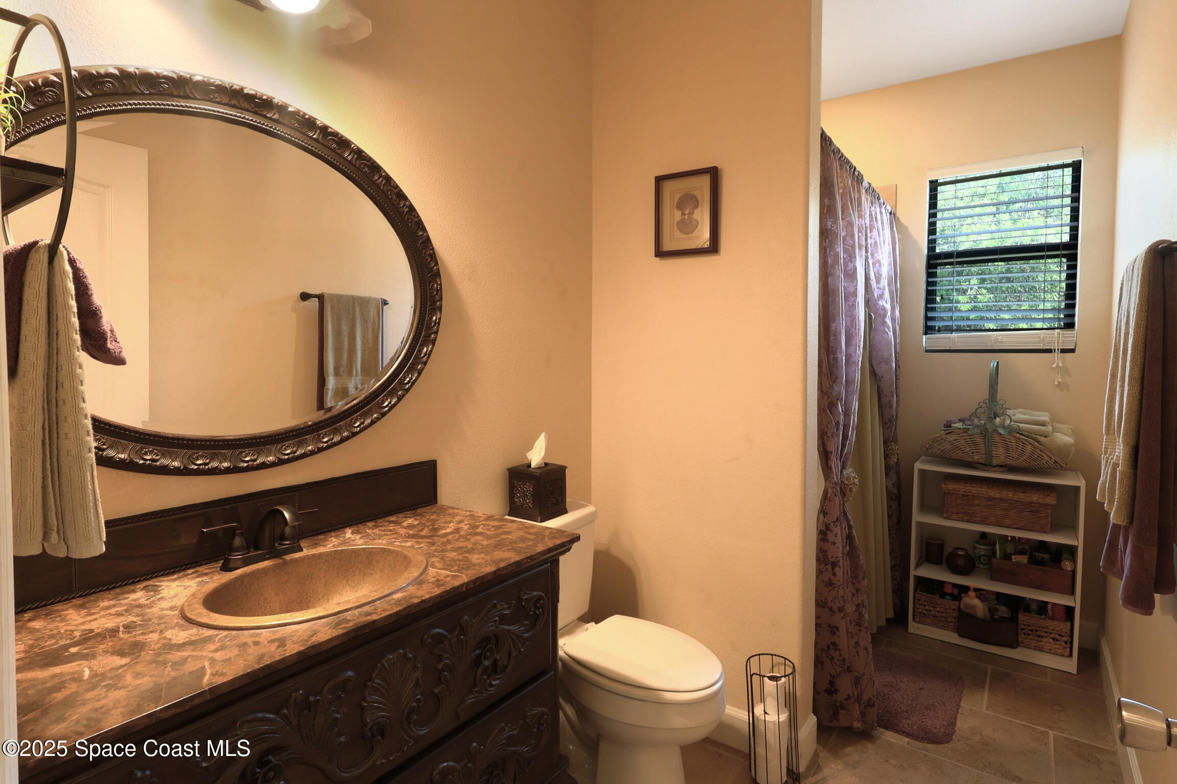 249 Franzing Street Palm Bay, FL 32908 - Photo 17 of 38 a bathroom with a sink a toilet and a mirror