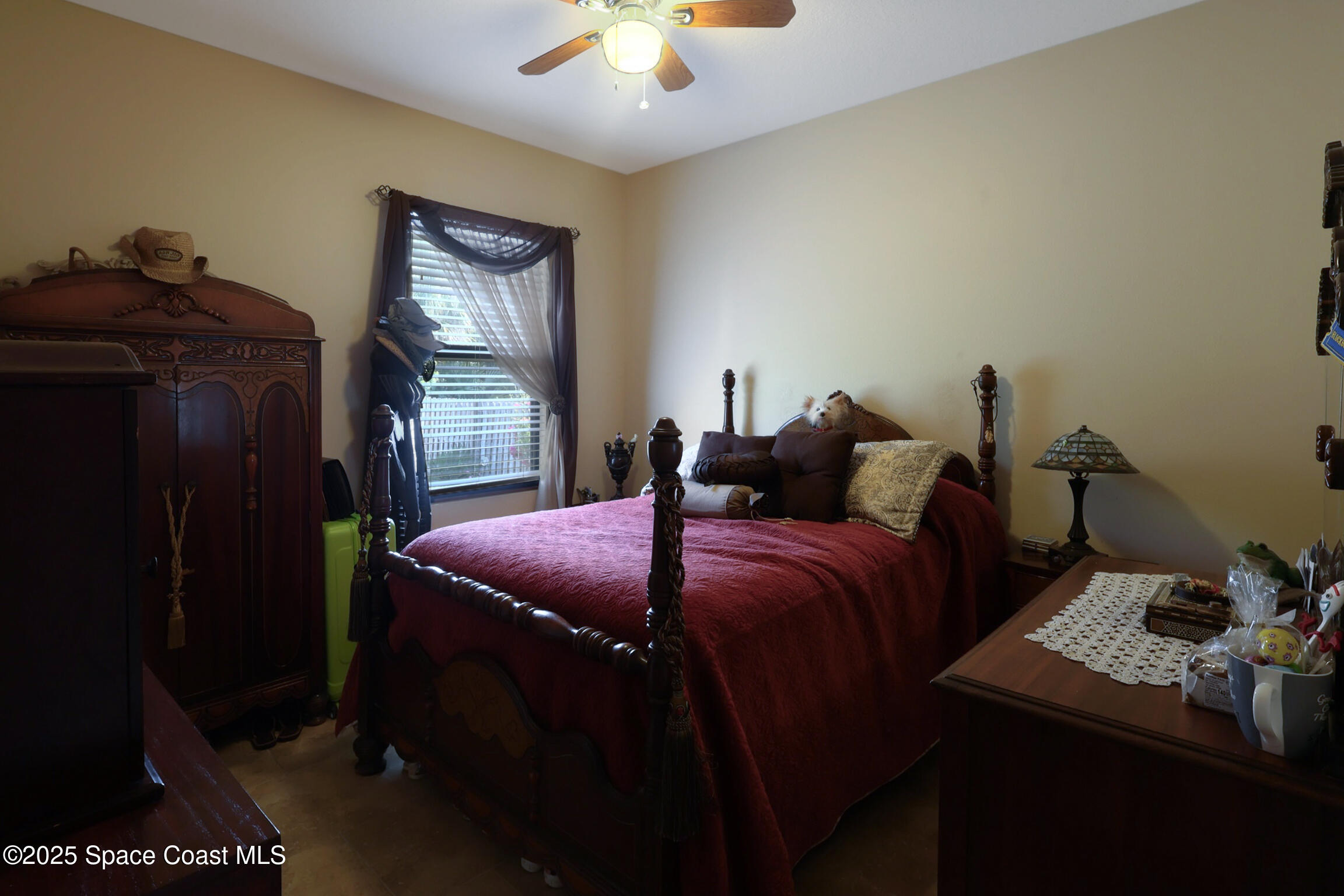 249 Franzing Street Palm Bay, FL 32908 - Photo 19 of 38 a bed sitting in a bedroom next to a lamp