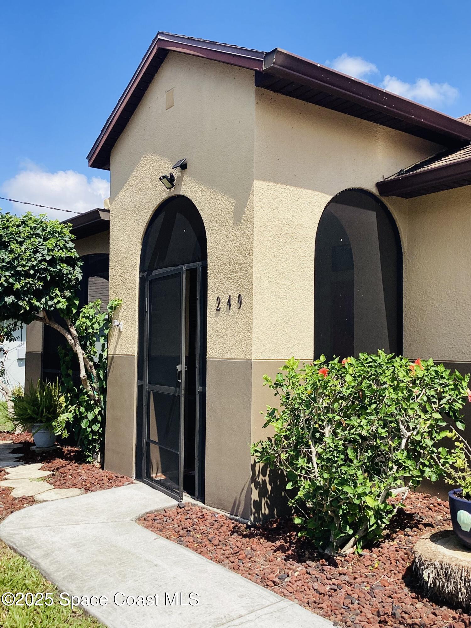 249 Franzing Street Palm Bay, FL 32908 - Photo 2 of 38 a front view of a house with a garden