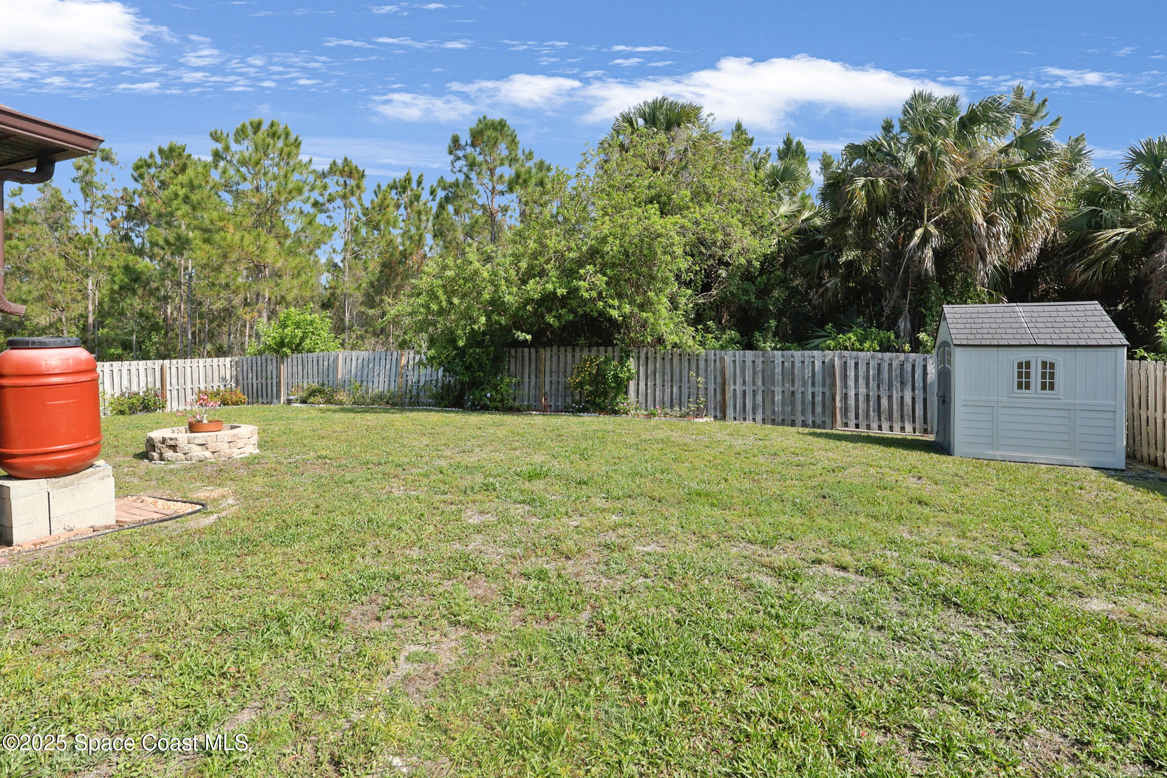 249 Franzing Street Palm Bay, FL 32908 - Photo 29 of 38 a view of a backyard with large trees