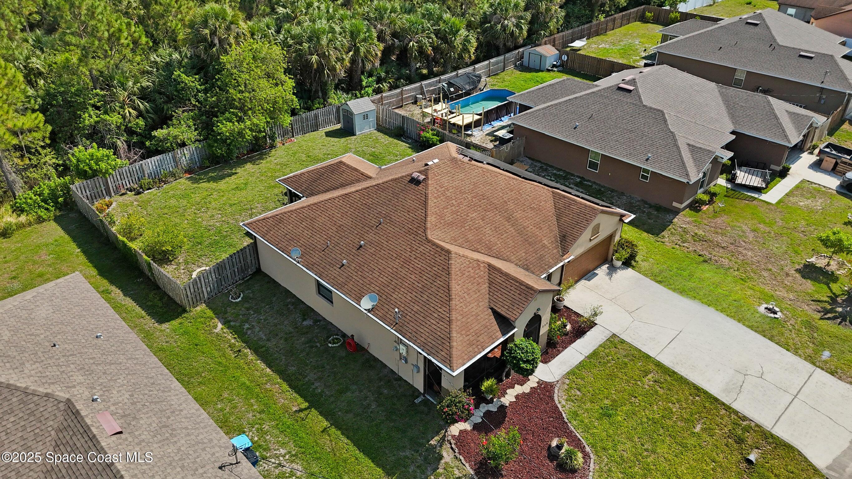 249 Franzing Street Palm Bay, FL 32908 - Photo 31 of 38 an aerial view of a house with a garden and swimming pool