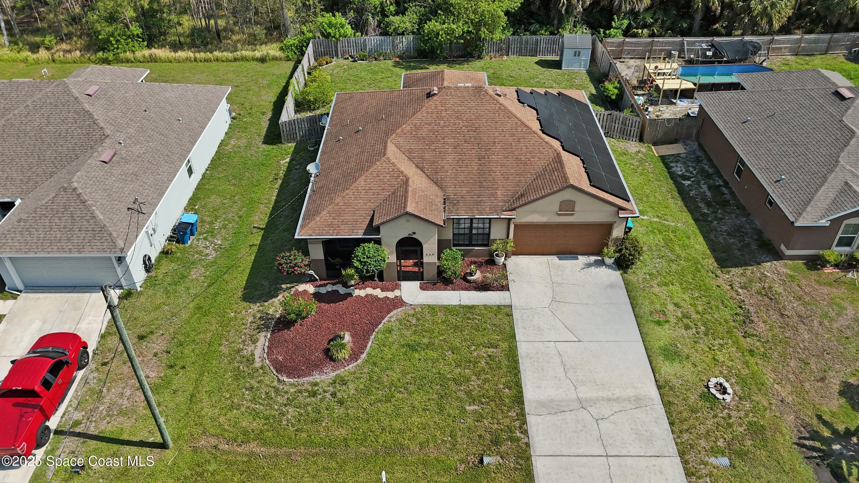249 Franzing Street Palm Bay, FL 32908 - Photo 32 of 38 an aerial view of a house with garden space and street view