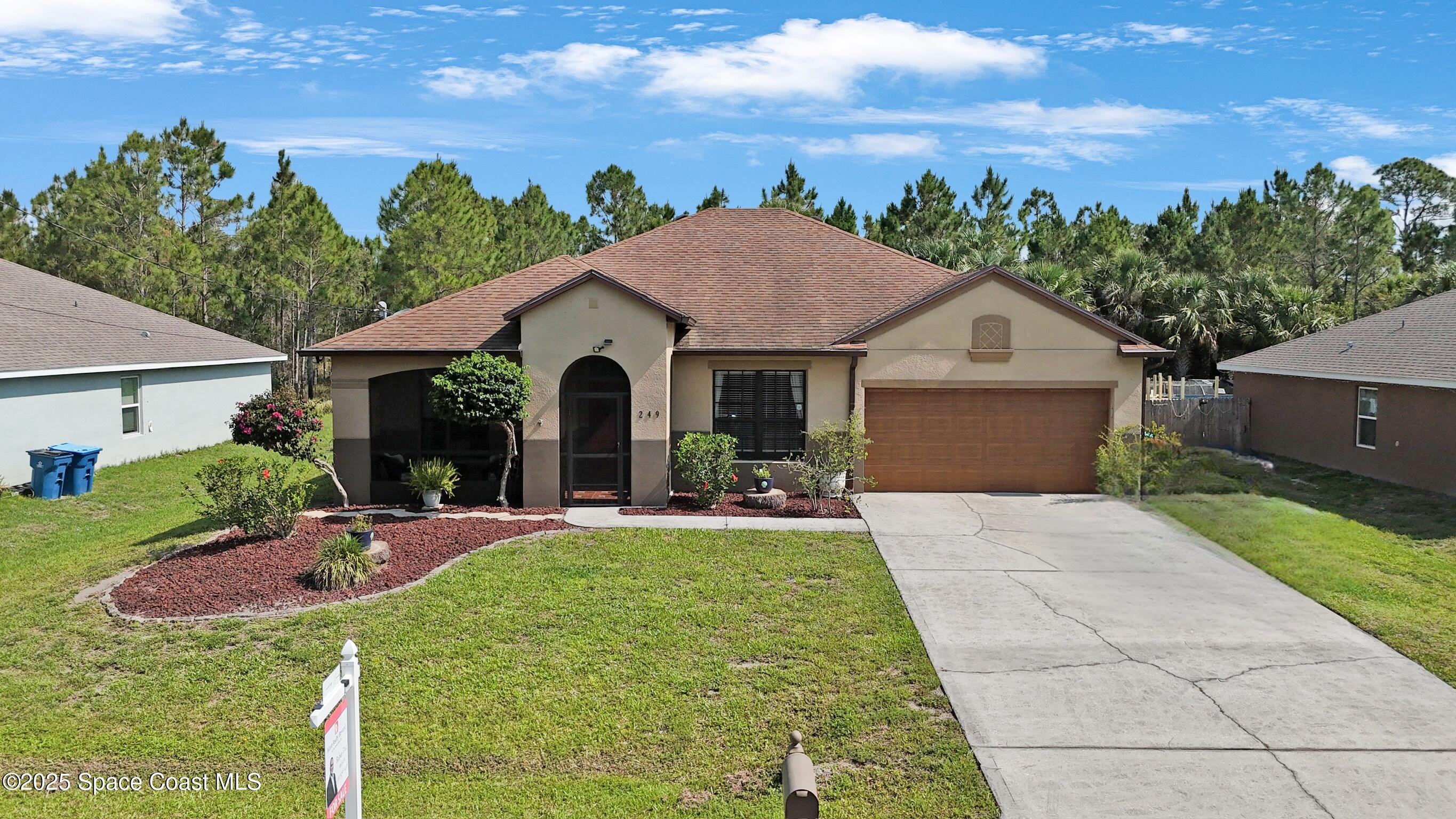 249 Franzing Street Palm Bay, FL 32908 - Photo 37 of 38 a view of a house with backyard and garden