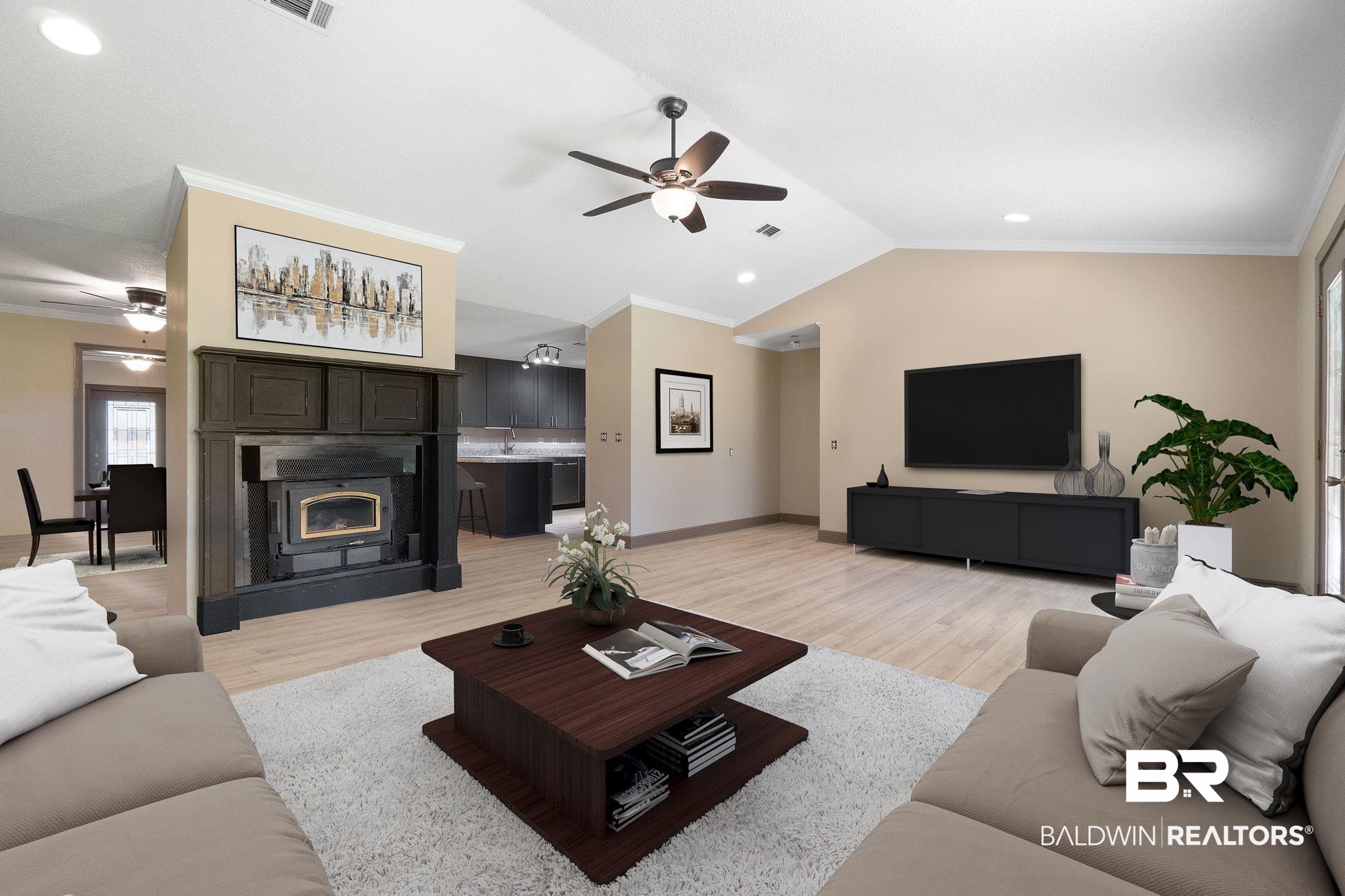 27300 C R Watson Road Robertsdale, AL 36567 - Photo 3 of 35 Living room with ornamental molding, vaulted ceiling, light hardwood / wood-style flooring, and ceiling fan