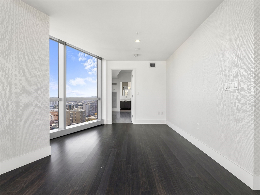 110 Stuart Street, Unit 23G Boston, MA 02116 - Photo 15 of 39 an empty room with wooden floor and outdoor view