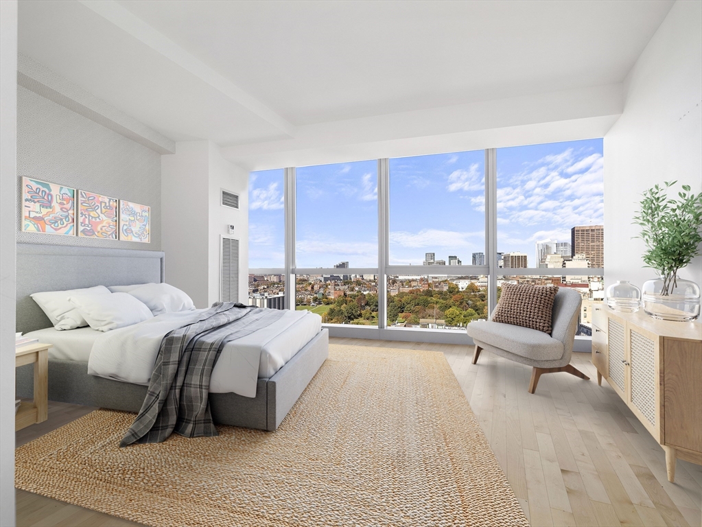 110 Stuart Street, Unit 23G Boston, MA 02116 - Photo 18 of 39 a spacious bedroom with a large bed and a large window