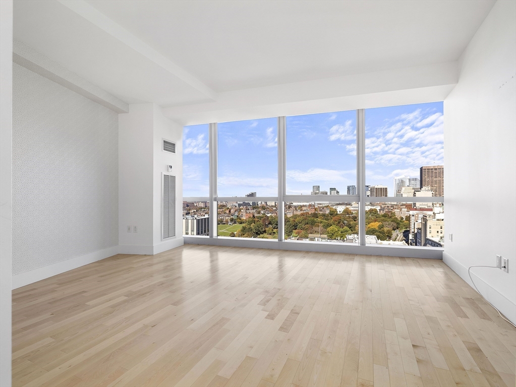 110 Stuart Street, Unit 23G Boston, MA 02116 - Photo 19 of 39 an empty room with wooden floor and windows