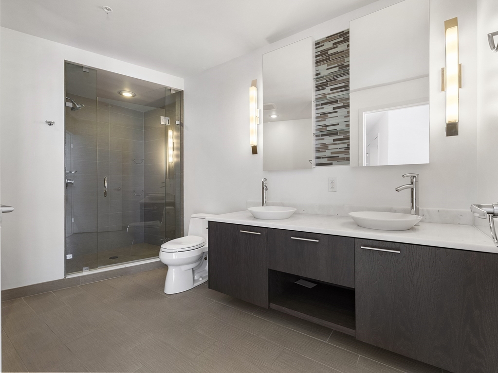 110 Stuart Street, Unit 23G Boston, MA 02116 - Photo 22 of 39 a bathroom with a sink shower and a toilet