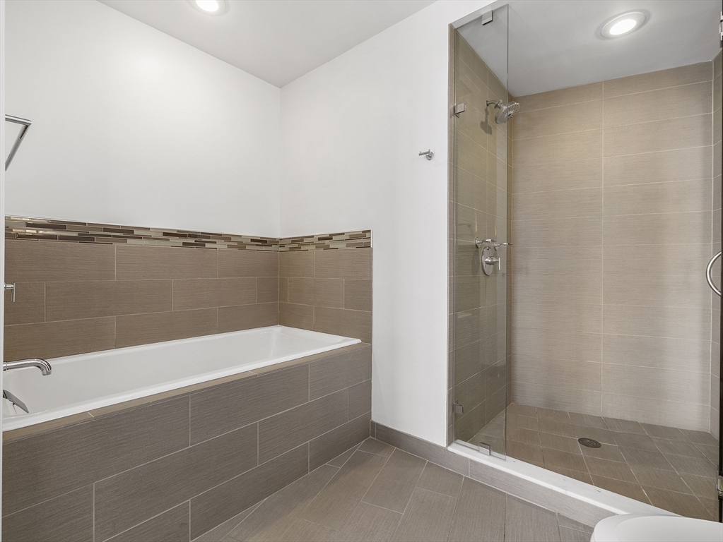 110 Stuart Street, Unit 23G Boston, MA 02116 - Photo 23 of 39 a bathroom with a bathtub and a shower