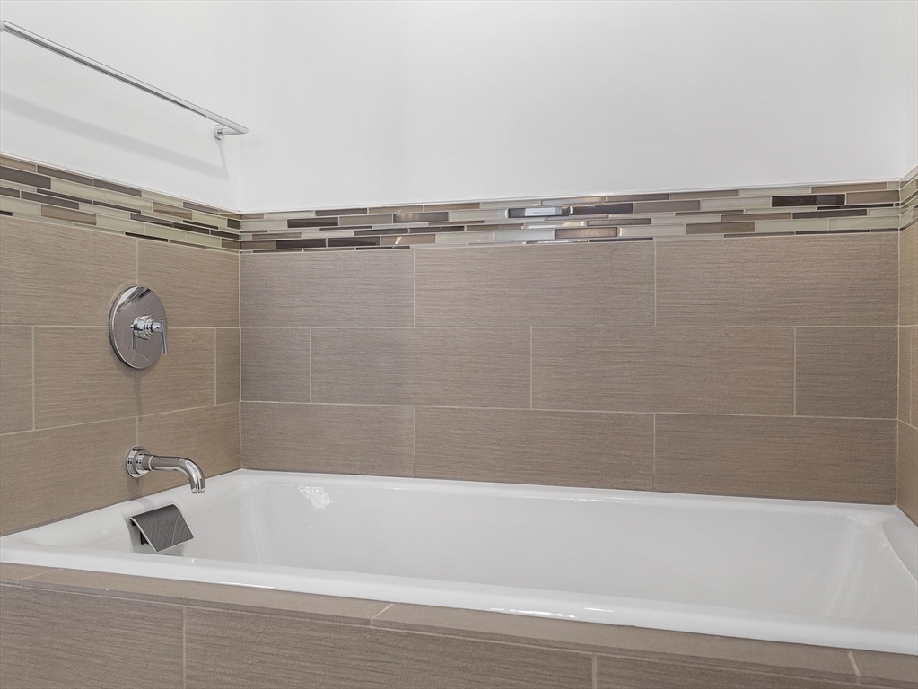 110 Stuart Street, Unit 23G Boston, MA 02116 - Photo 24 of 39 a bathroom with a shower and a bathtub