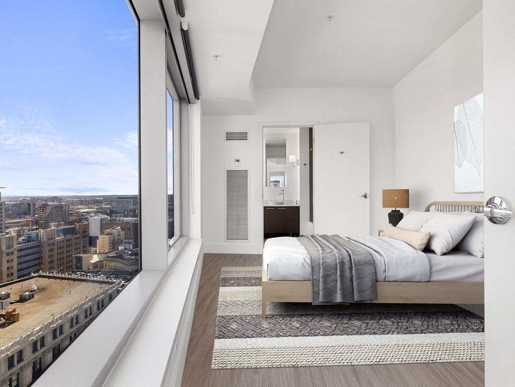 110 Stuart Street, Unit 23G Boston, MA 02116 - Photo 25 of 39 a spacious bedroom with a bed and a large window