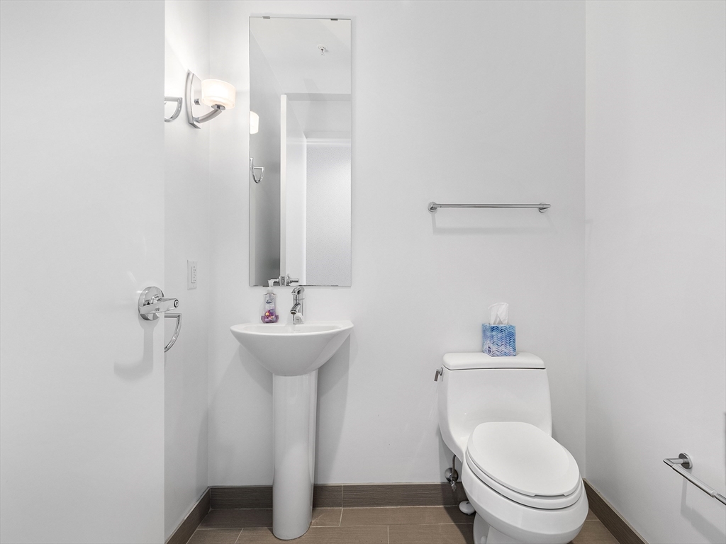 110 Stuart Street, Unit 23G Boston, MA 02116 - Photo 31 of 39 a bathroom with a sink a toilet and shower