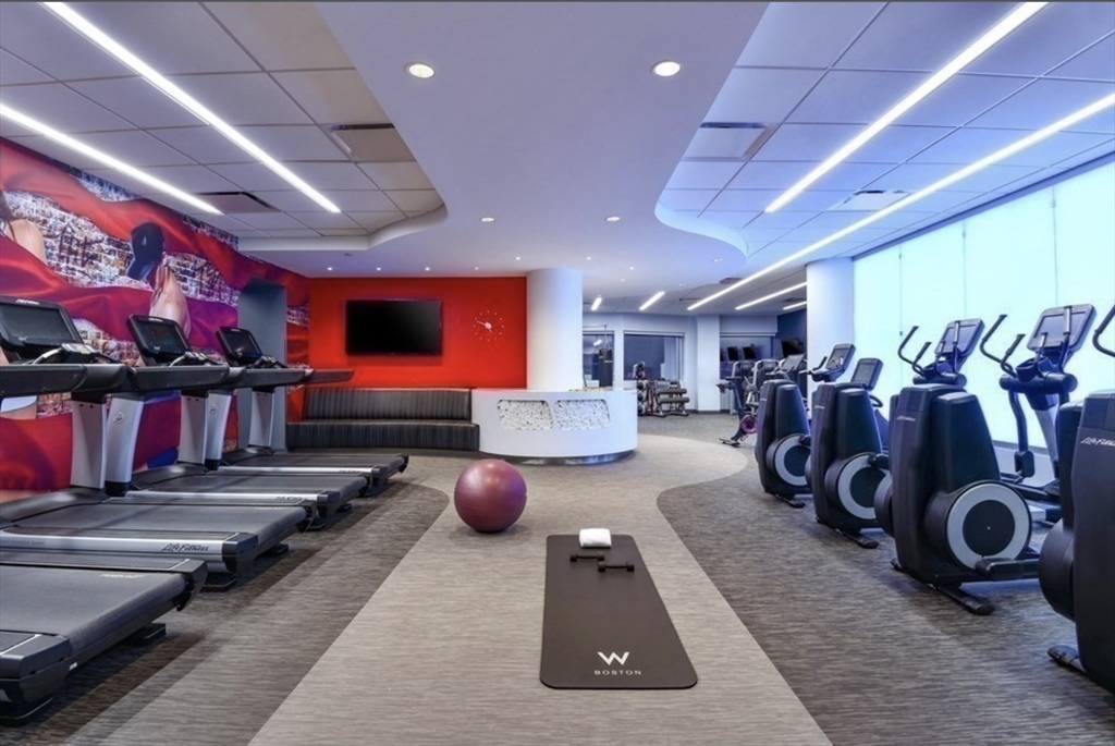 110 Stuart Street, Unit 23G Boston, MA 02116 - Photo 32 of 39 a room with gym equipment and a large window