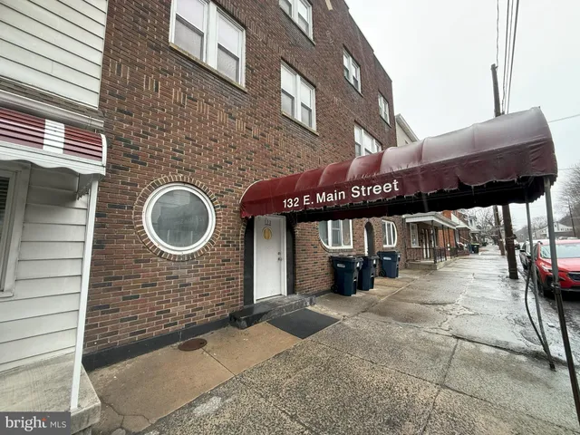 a view of a brick building with a canopy over it