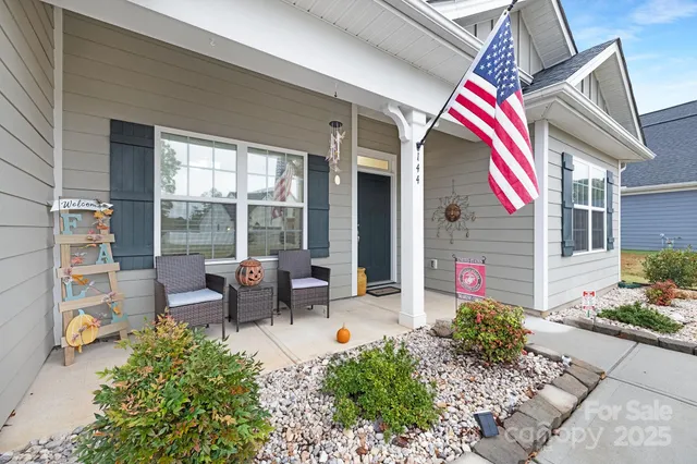 a front view of a house with sitting area