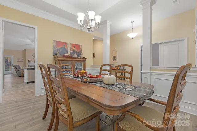 a view of a dining room with furniture and wooden floor