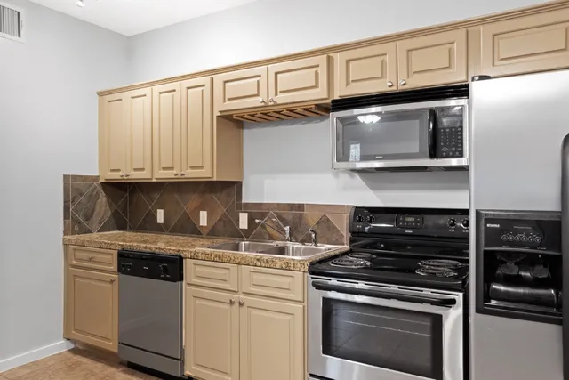 a stove top oven sitting inside of a kitchen